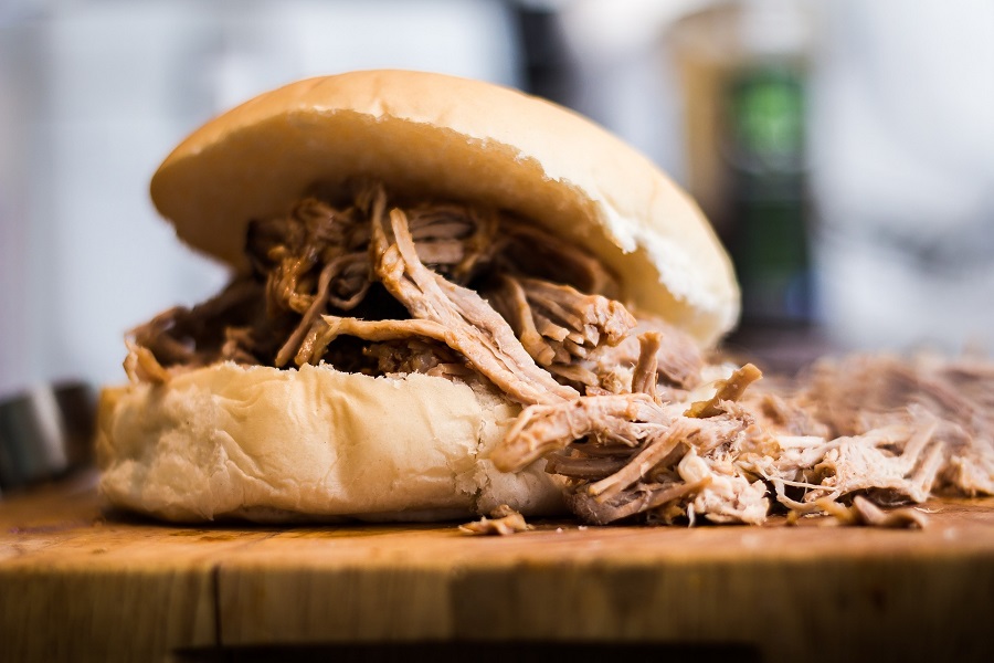 Slow Cooker Pulled Pork Recipes Close Up of a Pulled Pork Sanwich on a Cutting Board