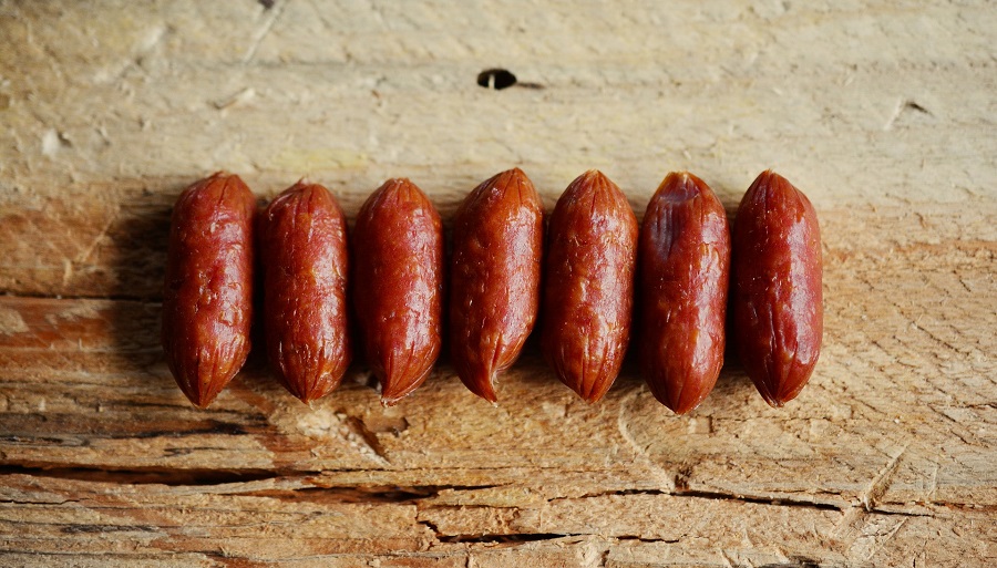 Crockpot Little Smokies with Brown Sugar Recipes Finished Sausages in a Row on a Wooden Surface