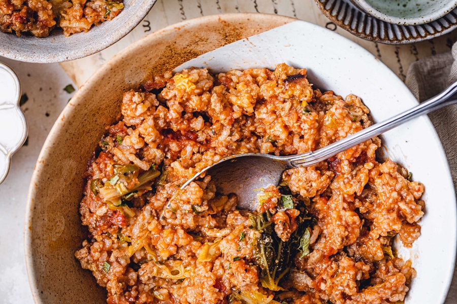 Crockpot Unstuffed Cabbage Rolls Close Up of a Bowl of Unstuffed Cabbage Rolls with a Spoon Inside