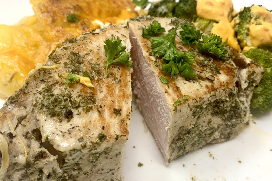 Instant Pot Frozen Pork Chops Close Up of a Pork Chop Cut in Half with Potatoes Au Gratin