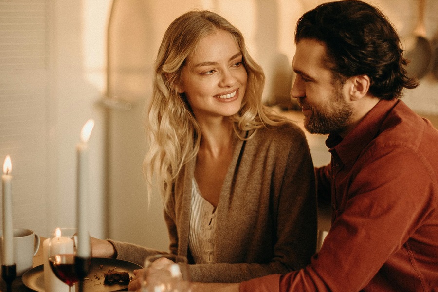 Romantic Instant Pot Recipes for Two a Couple Sitting at a Table in a Kitchen with Candles Lit