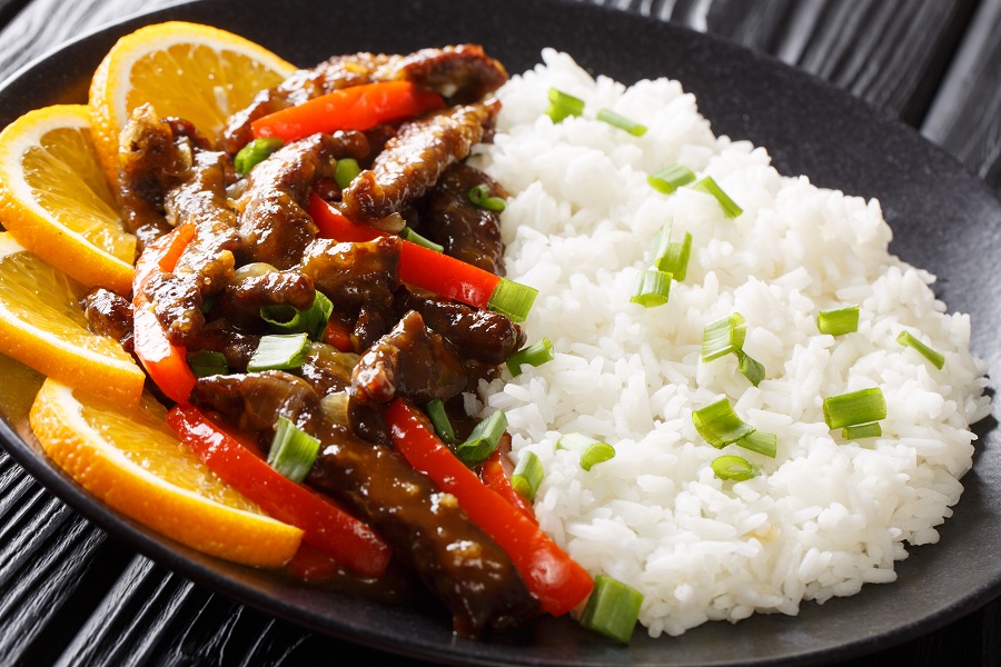Crockpot Pepper Steak Recipes Close Up of a Plate of Pepper Steak with Rice and Orange Slices